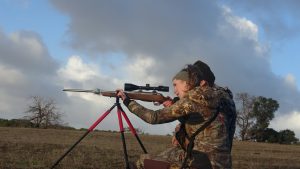 Looking through the scope of a rifle while hunting 